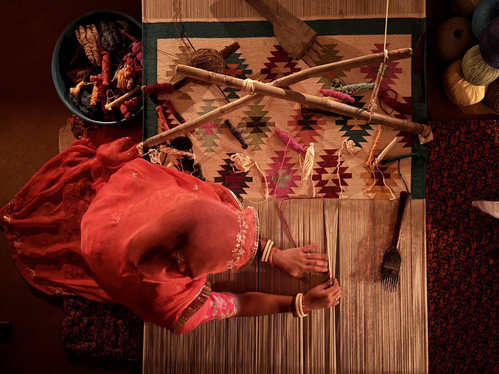 Artisans from Jodhpur craft weavers hand-weaving a traditional rug using age-old techniques in Rajasthan