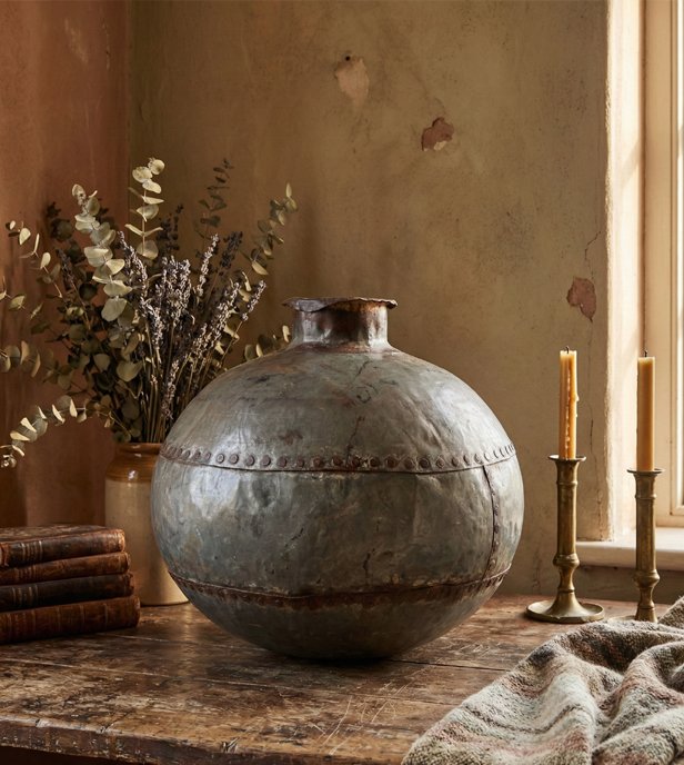 Vintage home décor setup with handcrafted elements, soft textures, and earthy tones creating a warm, cozy interior.